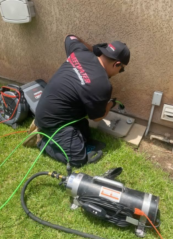 Plumber conducting a camera inspection through a drainpipe.