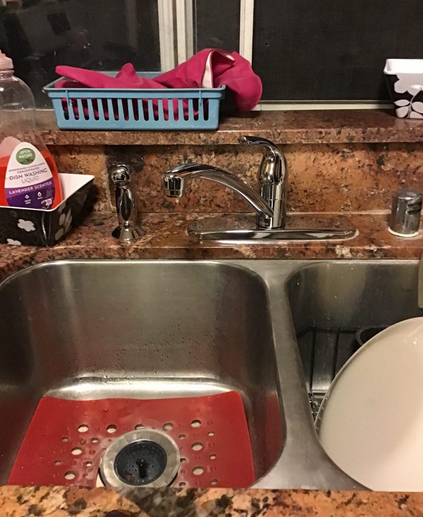 A newly installed kitchen sink and faucet.