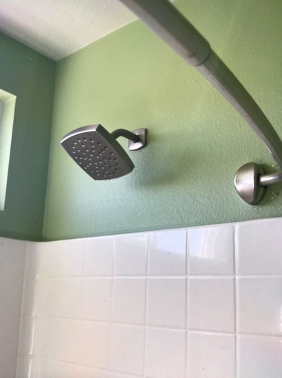 A shower head in the bathroom.