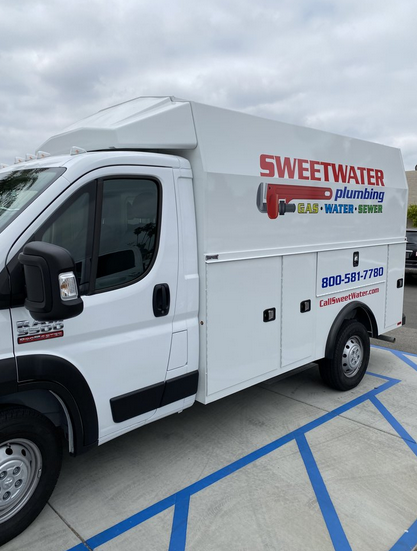 A white van standing outside a building.