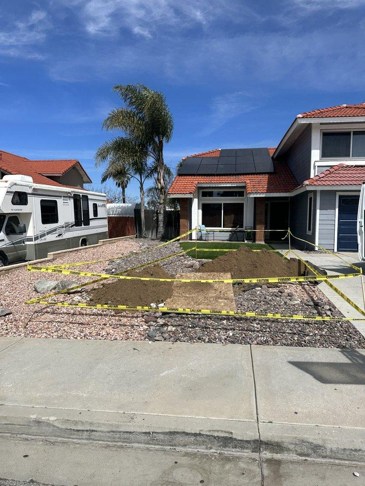 Residential home with yellow caution tape indicating work zone.