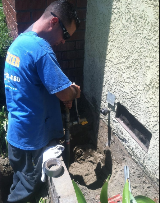 A plumber fixing a gas line.