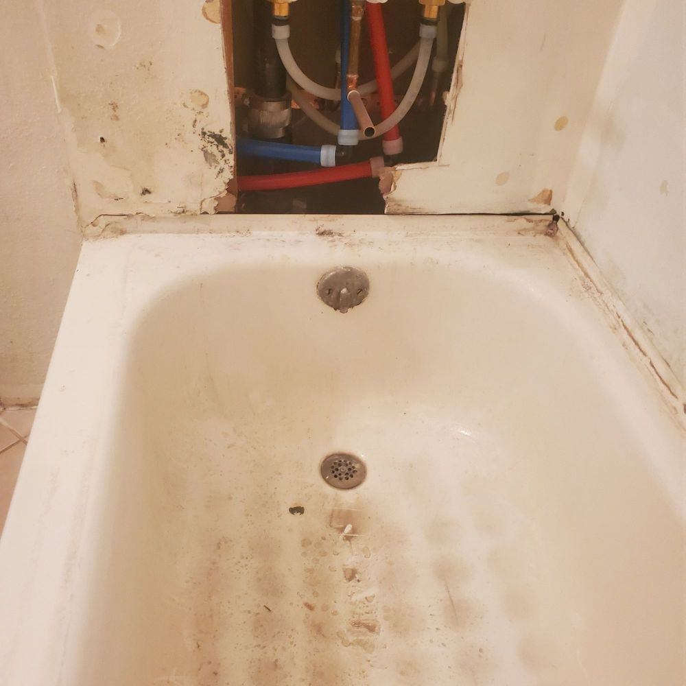 damaged bathtub and plumbing pipe system showing