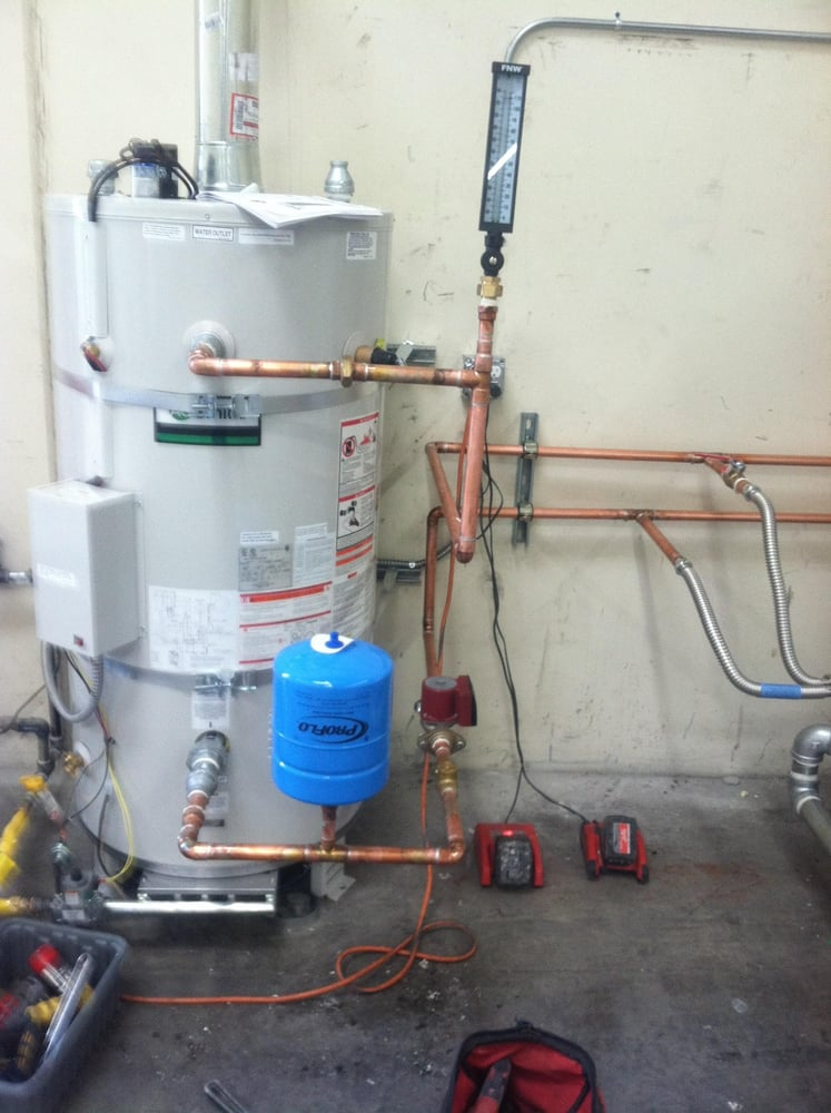 A standard tank water heater installed in a home utility area.