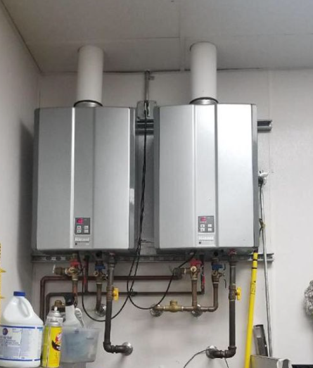Two water heaters installed side by side in a home.