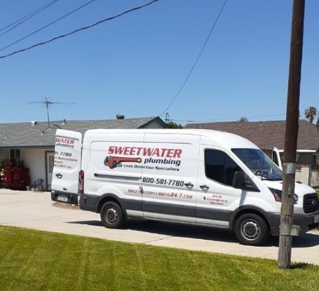 A Sweetwater Plumbing van outside a home for water heater installation in Chino.