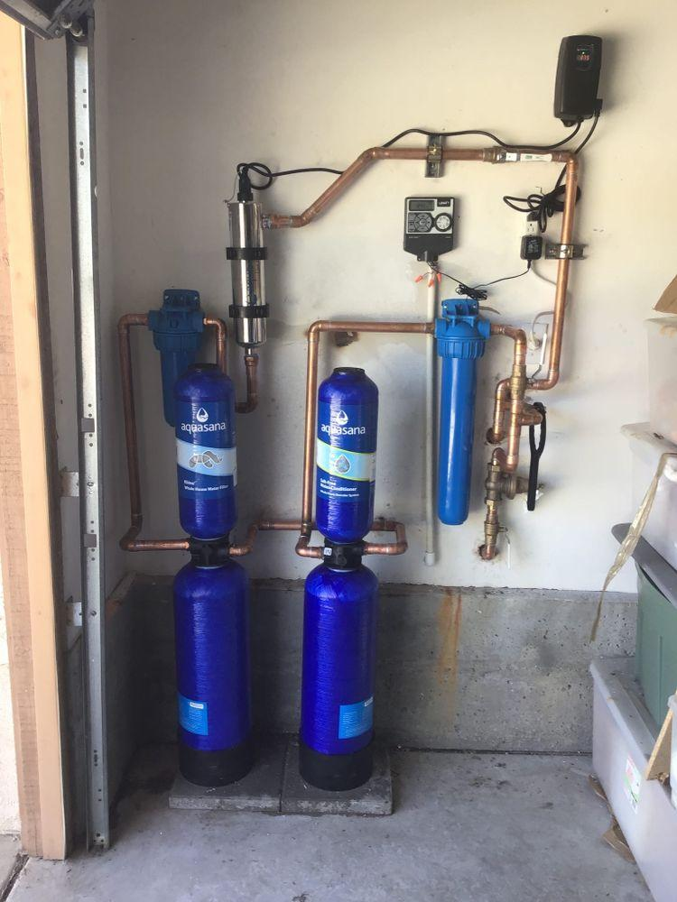 A close-up of a smart leak detection device installed on a pipe.