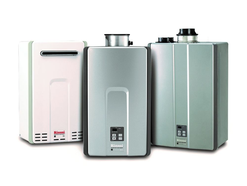 Array of compact tankless water heaters mounted on a wall with sleek digital control panels.