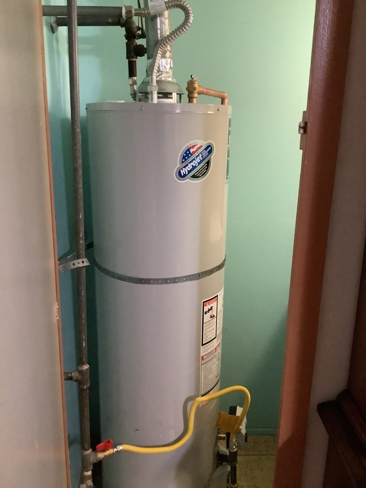 Residential water heater neatly installed inside a closet with minimal clearance.