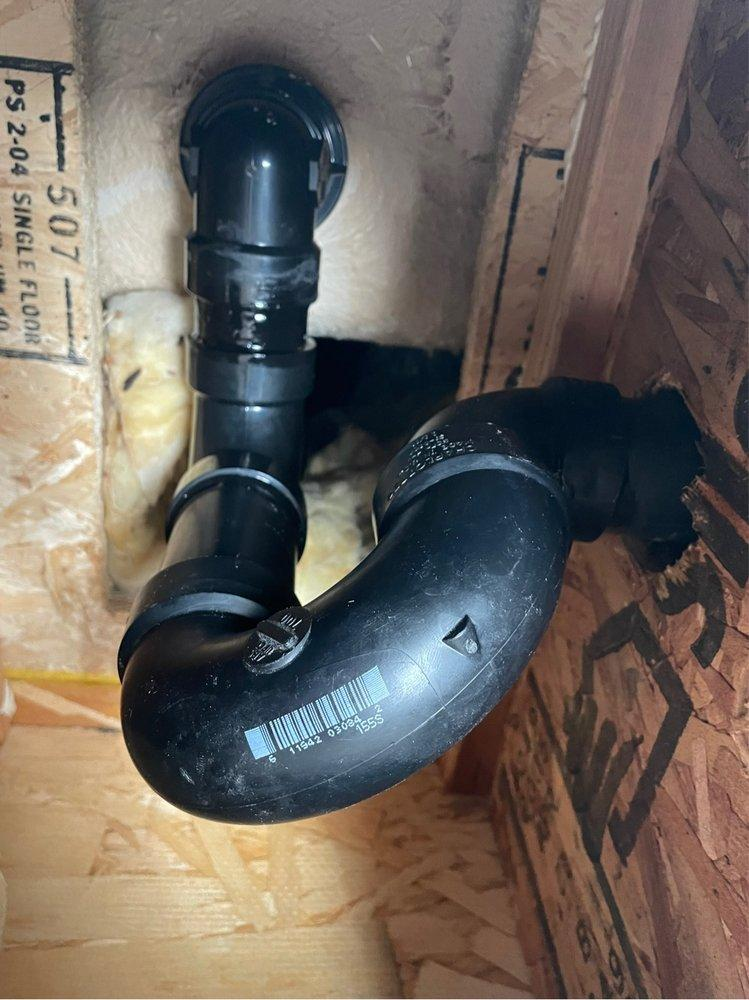 A black pipe installed on a wall