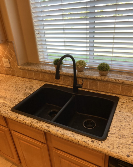 New metal kitchen sink fixtures.