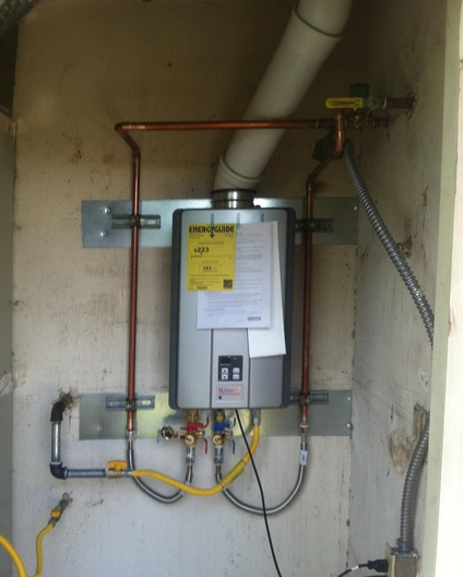 A tankless water heater is installed on a wall.
