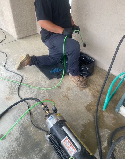 A plumber using modern drain cleaning equipment.