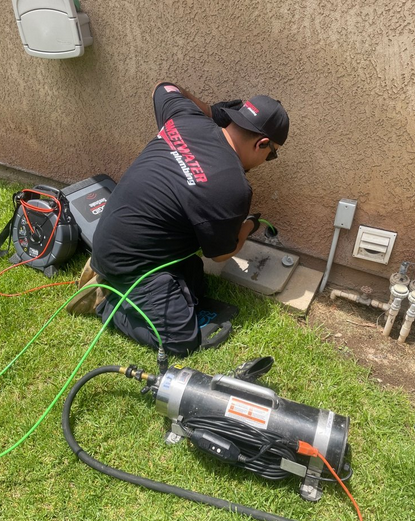 A professional using modern tools for drain cleaning.