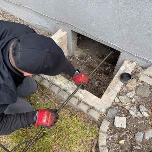 Visible water damage and exposed piping showing a slab leak beneath a home’s foundation.