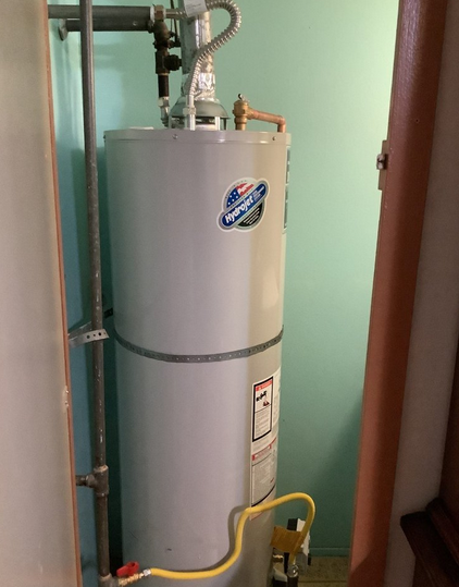 Gas water heater installation in a home.