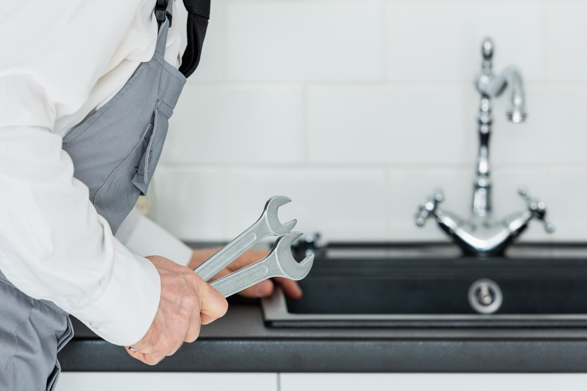 A plumber fixing a faucet.