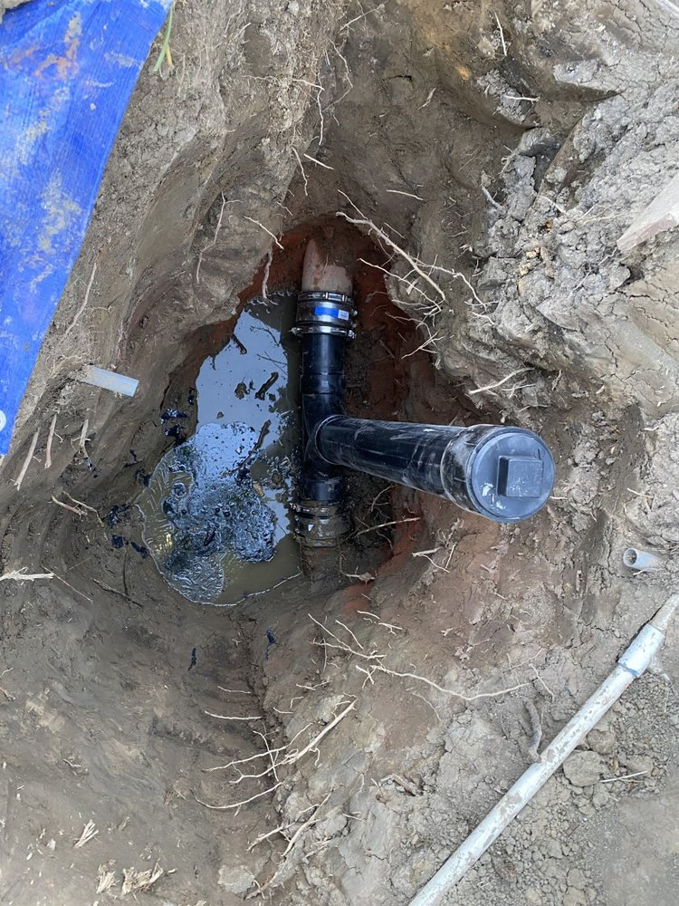 a hole dug inside the ground to expose a water leak in the pipes