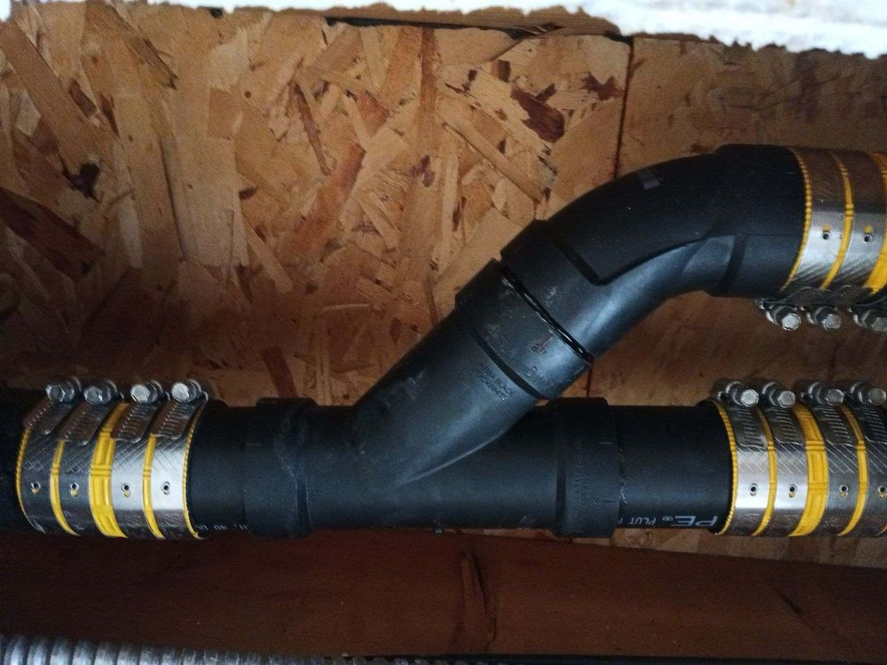 black pipes connected to each other using stainless steel joints
