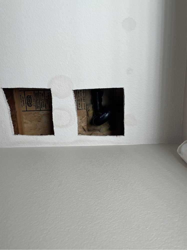warm water spots forming on the drywall, leading to removing the wall to fix pipes