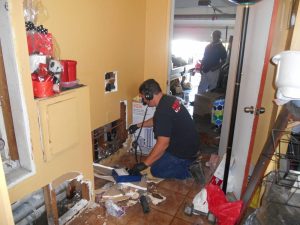 Plumber inspecting residential gas line for safety risks