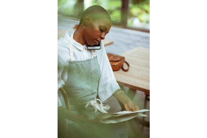 A woman holding a phone to her ear