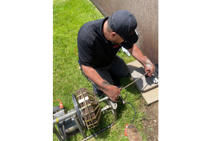 Plumber using professional equipment to clear clogged drains